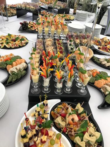 a long table filled with plates of food at Carina Hotel in Tczew