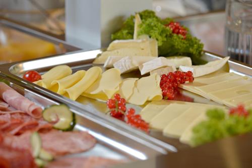 a tray of cheese and other foods on a table at Posthotel Mayrhofen in Mayrhofen