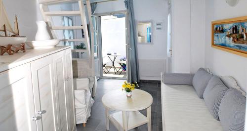 a living room with a couch and a table at Anthousa Hotel in Apollonia