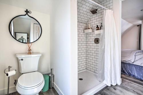 a bathroom with a toilet and a shower with a mirror at Cozy Plymouth Cottage with Medicine Lake View! in Minneapolis