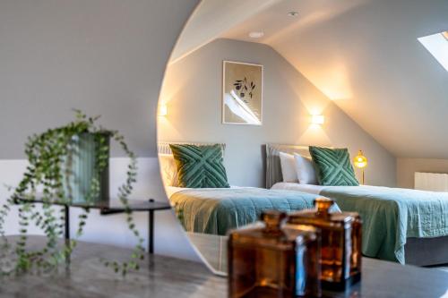 a attic bedroom with two beds and a mirror at Pawson House in York