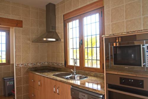 a kitchen with a sink and a microwave at Casa rural Villa Aljambra in Albox