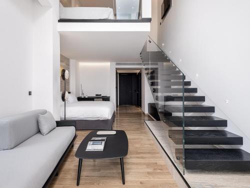 a living room with a staircase and a couch at The Tanneries Hotel & Spa - a Member of Design Hotels in Chania Town