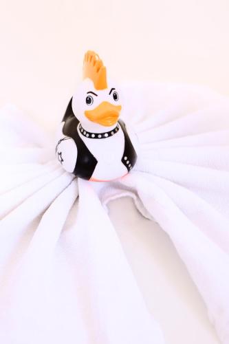 a rubber duck toy sitting on a white blanket at Hotel Wulff in Bad Sassendorf