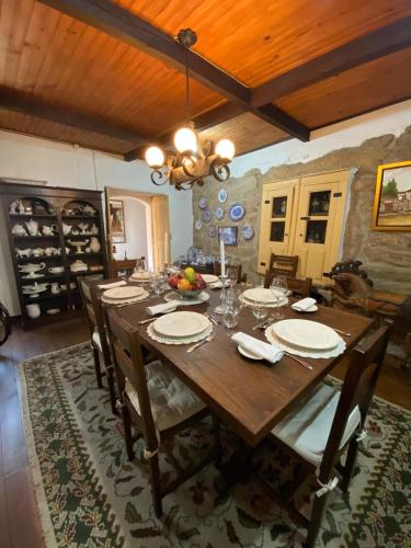 a dining room with a wooden table and chairs at Casa do Beco B&B Douro - Guest House in Parambos