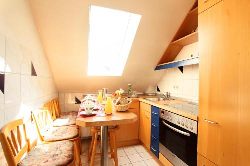 a small kitchen with a table and a window at Hotel Wulff in Bad Sassendorf