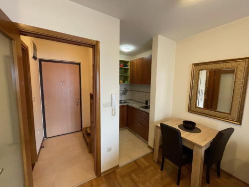 a kitchen and dining room with a table and a mirror at Exclusive studio, great location in Podgorica