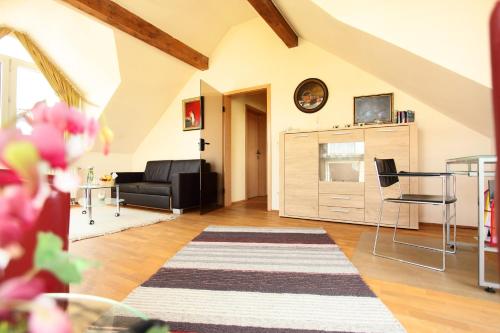 a living room with a couch and a table at Hotel Wulff in Bad Sassendorf
