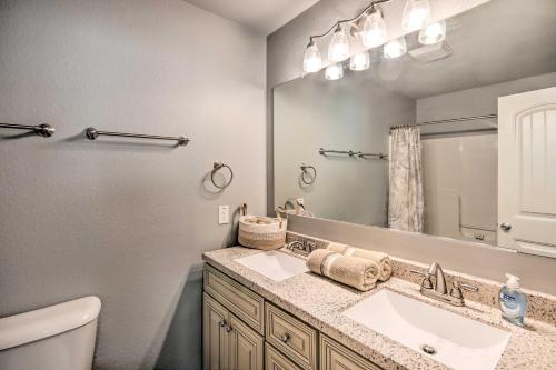 a bathroom with a sink and a mirror at Cozy Duplex, Walk to Bentonville City Square! in Bentonville