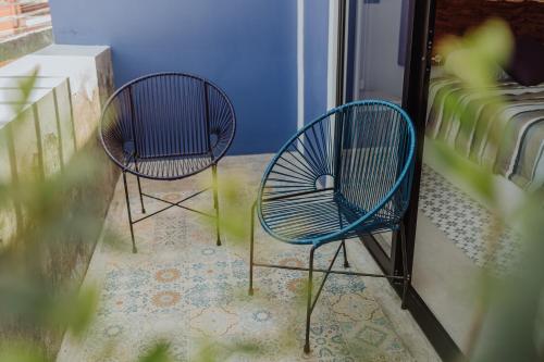 two blue chairs sitting on a balcony at Villas Colón 18 in Coatepec