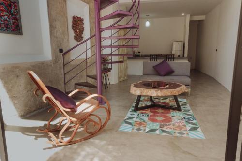 a living room with a spiral staircase and a table at Villas Colón 18 in Coatepec