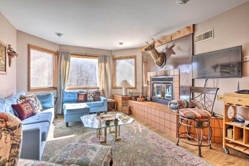a living room with a blue couch and a fireplace at Next to Shawnee Mtn Ski Area Inviting Condo! in East Stroudsburg
