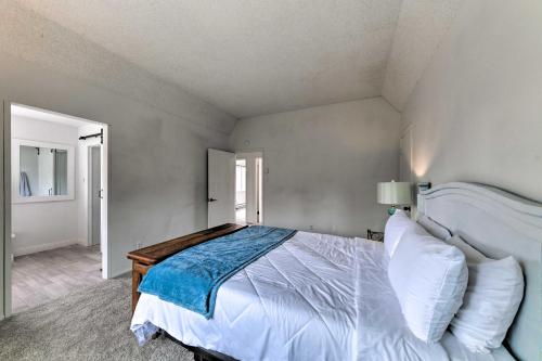 a bedroom with a large bed with white sheets at Mtn Escape with Deck and Views - Near Race Track! in Ruidoso Downs
