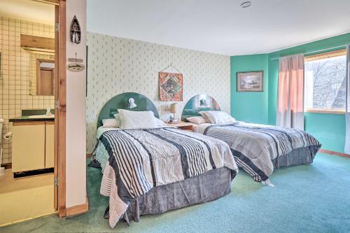 two beds in a room with green walls at Next to Shawnee Mtn Ski Area Inviting Condo! in East Stroudsburg