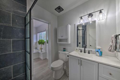 a bathroom with a toilet and a sink and a shower at Mtn Escape with Deck and Views - Near Race Track! in Ruidoso Downs