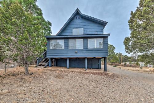 a blue house on the side of a road at Mtn Escape with Deck and Views - Near Race Track! in Ruidoso Downs