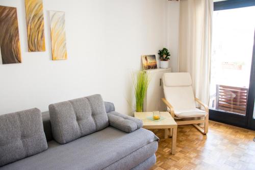 a living room with a couch and a chair at Apartment San Izola - near the beach in Izola