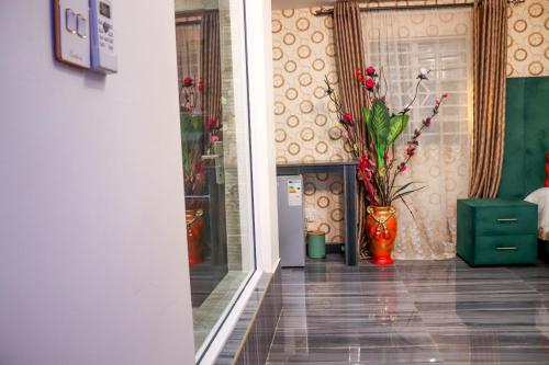 a hallway with a vase with flowers in it at Gold Crown International Hotel With Complementary Breakfast and WiFi in Johannesburg