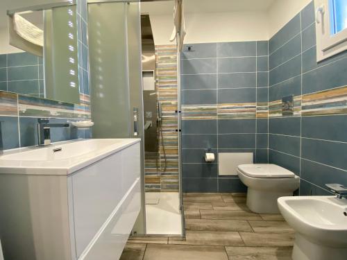 a bathroom with a sink and a toilet and a shower at IN CENTRO ROOMS Vicino Cefalù SELF-CHEK-IN in Campofelice di Roccella