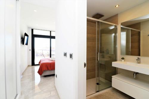 a bathroom with a shower and a sink and a bed at Sunset Waves 1-2 in Benidorm