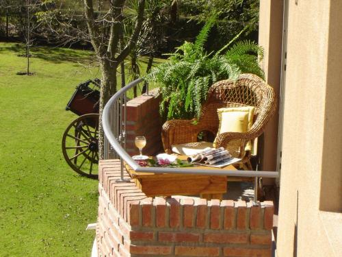 a brick wall with a chair and a glass of wine at Don Numas Posada & Spa in San Lorenzo