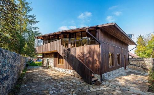 a wooden house with a balcony on a stone road at EcoLife Lodge Hotel & Restaurant in Stepʼanavan