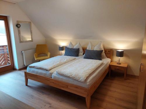 a bedroom with a large bed with blue pillows at Anna's Home - Ferienwohnungen in Ratsch an der Weinstraße