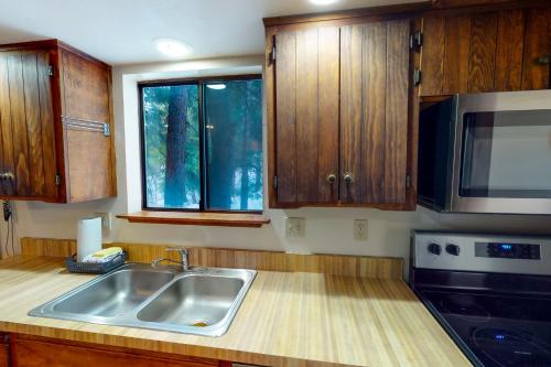 a kitchen with a sink and a microwave at Forest Glen in Yosemite West