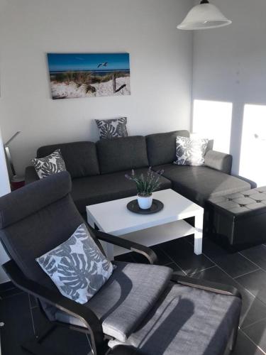 a living room with a couch and a table at Feriendomizil Dornum Haus Margarete mit Wallbox in Dornum