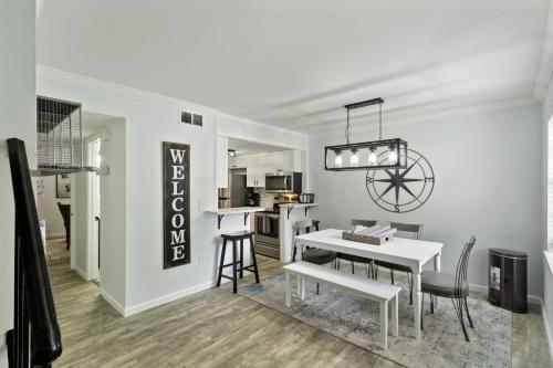 a kitchen and dining room with a white table and chairs at #49 Cheerful 2 BDR with Pool & Assigned 2 Parking in Hilton Head Island