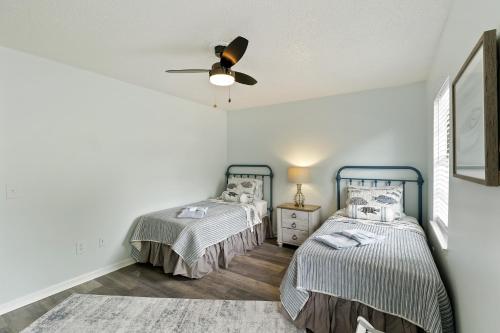 a bedroom with two beds and a ceiling fan at #49 Cheerful 2 BDR with Pool & Assigned 2 Parking in Hilton Head Island