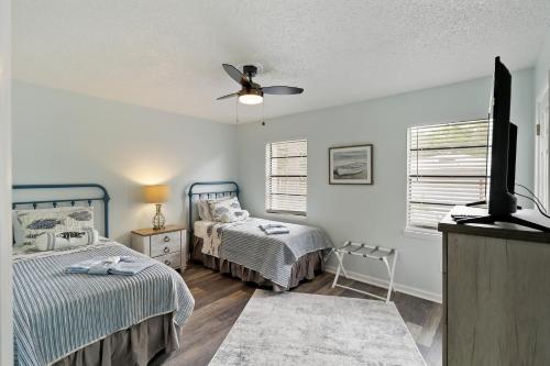 a bedroom with two beds and a ceiling fan at #49 Cheerful 2 BDR with Pool & Assigned 2 Parking in Hilton Head Island
