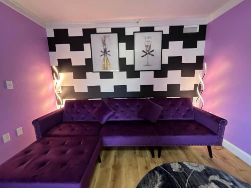 a purple couch in a room with a wall at Orbits Inn in Somerset