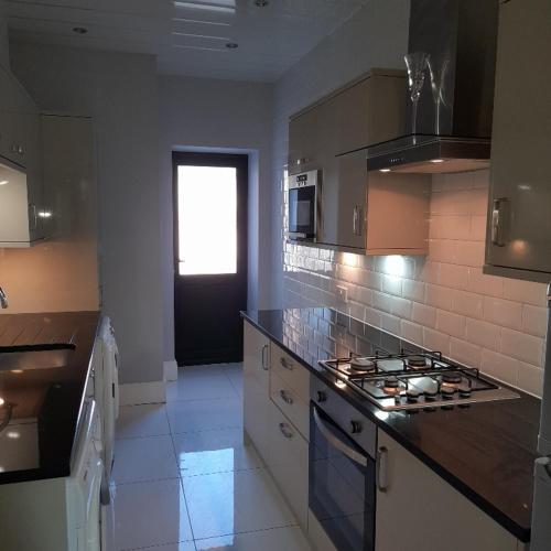 a kitchen with a stove top oven in a kitchen at Lytham Apartment in Lytham St Annes