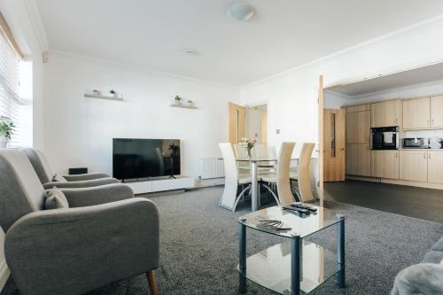 a living room with a couch and a table at Spacious 2 bedroom flat near beach and town centre in Bournemouth
