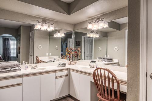 a bathroom with two sinks and a large mirror at Quiet and Serene Condo in Branson in Branson