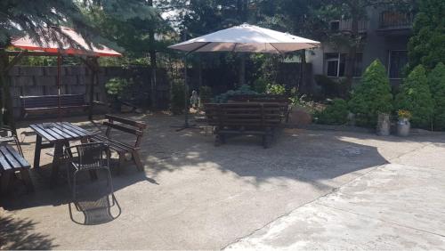 a patio with a table and an umbrella at Kujawianka in Ciechocinek