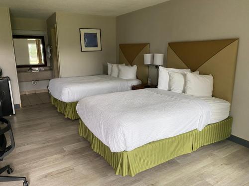 A bed or beds in a room at Days Inn by Wyndham Brunswick/St. Simons Area