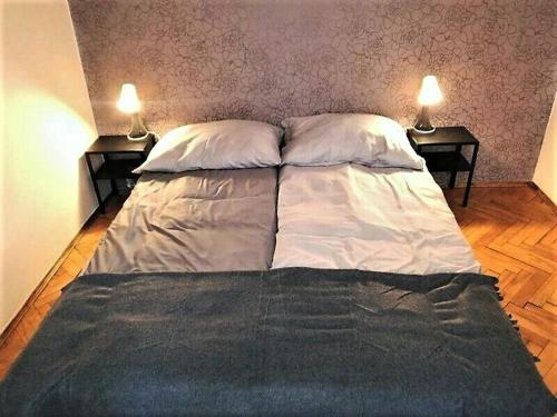 Кровать или кровати в номере Floriańska NewTown