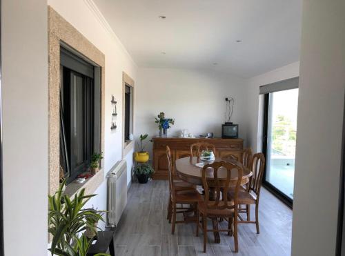 a dining room with a table and chairs at Terraço d’Aldeia in São Pedro do Sul