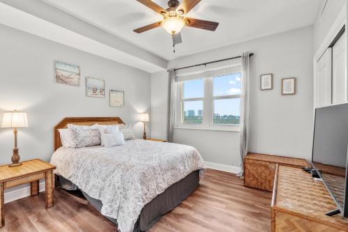 a bedroom with a bed and a flat screen tv at Santo Amaro 801B - Lost Key Golf & Beach in Perdido Key