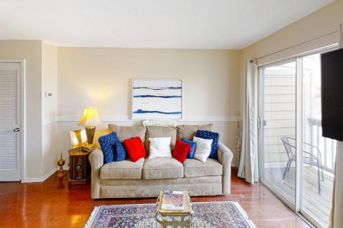 a living room with a couch with red and blue pillows at Riverfront Retreat in Nashville