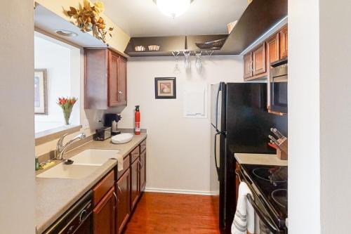 a kitchen with a black refrigerator and a sink at Riverfront Retreat in Nashville