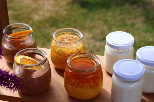 a wooden table with jars of honey and lemonade at Hotel Boutique Casa Werner in Puerto Varas