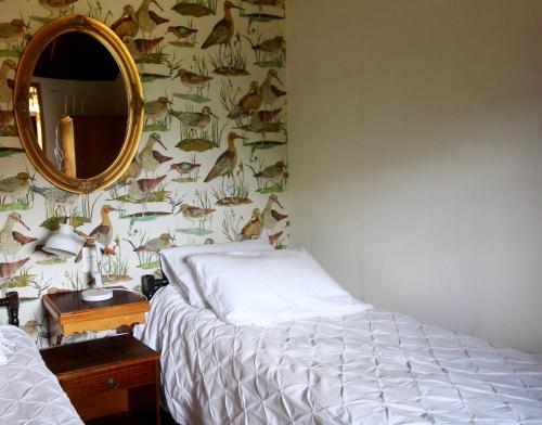 a bedroom with a bed and a mirror at Hotel Boutique Casa Werner in Puerto Varas