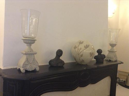 a table with two lamps and a vase on it at Hotel Acapulco in Montpellier