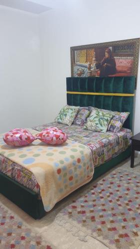 a bed with pillows on it in a room at Beautiful Apartment Holiday in Casablanca