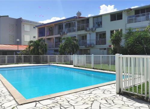 a swimming pool in front of a building at Fleur d'Acacia in Les Trois-Îlets