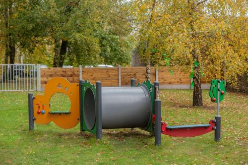 a playground in a park with two swings at Radisson Blu Hotel, Cork in Cork
