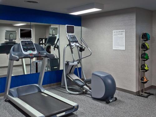a gym with a treadmill and elliptical machines at Sonesta Suites Scottsdale Gainey Ranch in Scottsdale